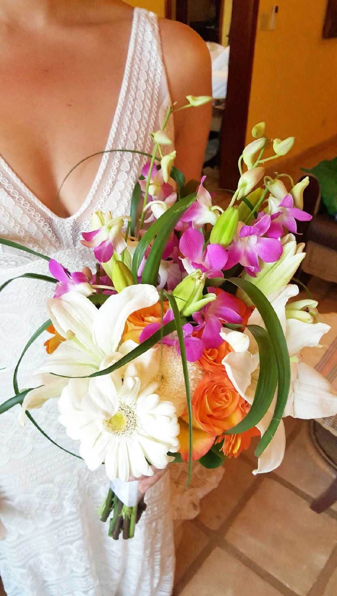Hand-tied tropical bridal bouquet with lilies, roses and orchids